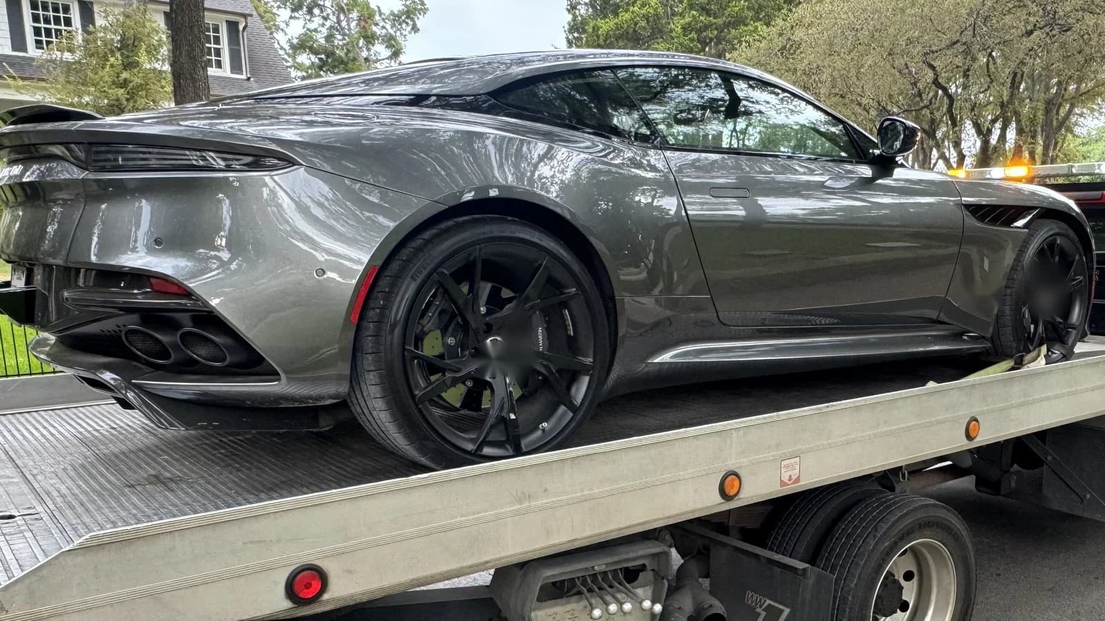 Exotic car towing in Dallas with a low-clearance performance vehicle secured on a flatbed