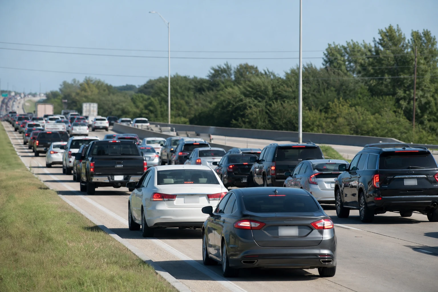 Brake wear Dallas stop-and-go traffic with brake lights illuminated on a congested highway